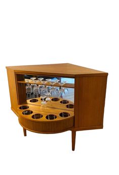 a wooden cabinet with wine glasses in it