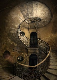 a spiral staircase in an abandoned building