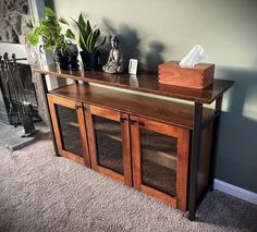 a wooden cabinet with glass doors on top