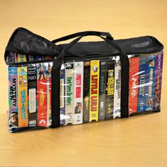 a bag filled with books sitting on top of a wooden floor