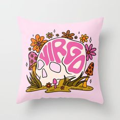 a pink pillow with an image of a skull and flowers in the background that says airo