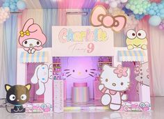 a hello kitty birthday party with balloons and decorations