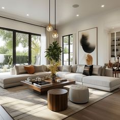 a modern living room with large windows and white couches in front of the sliding glass doors