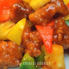 meat and pineapples are mixed together in a chinese style dish on a white plate