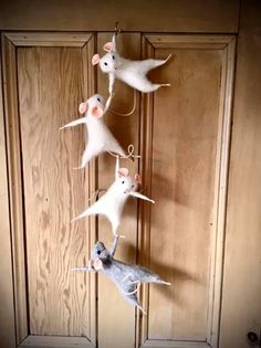 three mice are hanging on the door handle