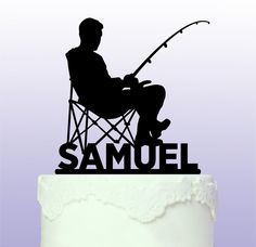 the silhouette of a man sitting in a chair on top of a cake with a fishing rod