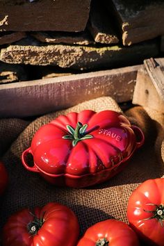 some red tomatoes sitting on top of a table