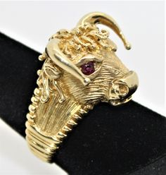 Vintage 1970's Handmade 14K Yellow Gold Bull Head Ruby Ring Made for zodiac Taurus Perfect gift for your loved one Ring length approximately; 34 mm Ring width approximately;24.10mm Total ring weigh 22.70g Item will be placed into a gift box. Free domestic shipping. Ornate Yellow Gold Ruby Ring Gift, Bull Ring, Birmingham Bull Ring, Bull Necklace, Vintage Yellow Gold Zodiac Jewelry, Yellow Gold Opal Ring, Opal Ring Gold, Golden Ring, Red Band