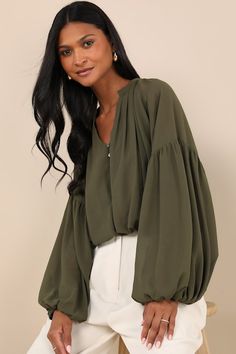 Transition through the seasons in style with the Lulus Season of Blooms Olive Green Balloon Sleeve Top! Lightweight woven chiffon shapes this top that has a V-neckline and long balloon sleeves with drop shoulders and elastic at the cuffs. Mother-of-pearl buttons accent the blousy bodice before it ends at an elasticized hem. Fit: This garment fits true to size. Length: Size medium measures 18.5" from shoulder to hem. Bust: Great for any cup size. Waist: Fitted - elastic waist allows stretch. Unde Olive Long Sleeve Top For Layering, Olive Long Sleeve Blouse For Fall, Green Balloon Sleeve Fall Top, Chic Green Balloon Sleeve Tops, Earth Tones Outfit, Casual Olive Button-up Tops, Fall Fashion Trends Casual, Green Top Outfit, Green Outfits For Women