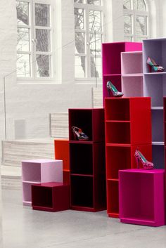 colorful shelving unit with high heels on each shelf