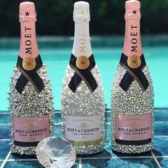 three bottles of champagne sitting next to each other