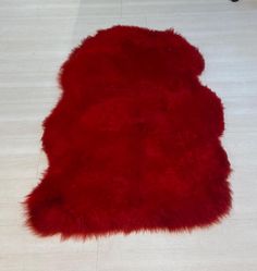 a red sheepskin rug is laying on the floor