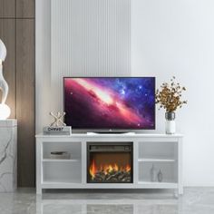 a flat screen tv sitting on top of a wooden entertainment center next to a fireplace