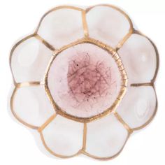 a white and gold flower shaped dish