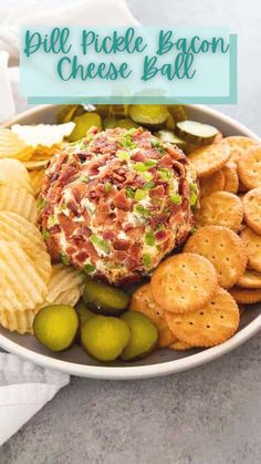 a bowl filled with cheese ball surrounded by crackers and olives