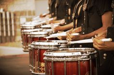 the drums are lined up and ready to be played in an orchestra or band performance