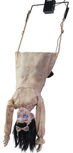 a creepy doll hanging upside down from the ceiling with its head and legs attached to it