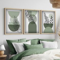 three framed art prints on the wall above a bed with green sheets and pillows in a bedroom