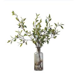 a vase filled with green leaves and twigs