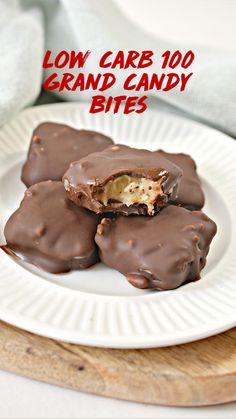 three chocolate covered cookies on a white plate