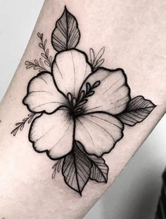 a black and white flower tattoo on the leg