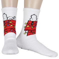 These Peanuts Snoopy and Red Dog House Holiday Fuzzy Gripper Slipper Socks are the great cozy accessory for the festive season. The soft, fuzzy socks feature a charming design of Snoopy lounging atop his red dog house, adorned with festive Christmas lights. Crafted from a comfortable blend of 98% polyester and 2% spandex, these socks offer warmth and flexibility. The soles are equipped with rubber grip dots to prevent slipping, while the ribbed cuff at the top ensures the socks stay securely in Holiday Socks Gift, Snoopy Holiday, Paws Socks, Holiday Socks, Fluffy Socks, Cozy Accessories, Mens Holiday, Fuzzy Socks