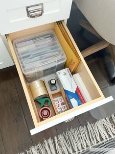 an open drawer with various items in it