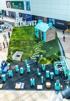 an aerial view of the inside of a building with people walking around and looking at it