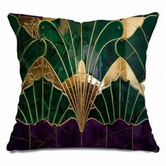 a green and gold pillow with an art deco fan design on it's back