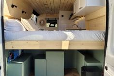 the interior of a camper van with its bed pulled up to it's side