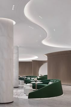 the interior of a modern restaurant with green and white furniture