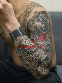 Koi fish tattoo, dragon tattoo art, Japanese tattoo design, transformation symbol ink, strength and perseverance tattoo, autumn leaves tattoo, serene aquatic tattoo, cultural body art, koi and dragon symbolism, Asian-inspired tattoo. Yakuza Style Tattoo, Japanese Snake, Japanese Snake Tattoo, Dragon Sleeve Tattoos, Men Tattoos Arm Sleeve