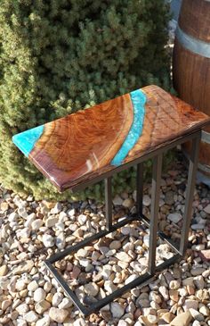 a wooden table sitting on top of a pile of rocks