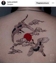 the back of a woman's shoulder with two birds flying over clouds and a red sun