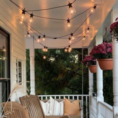 a porch covered in lots of lights and chairs