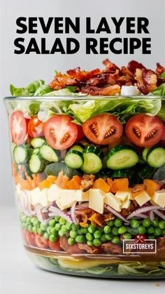 a salad in a large glass bowl with the title seven layer salad recipe