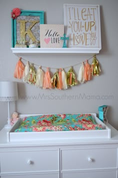 a baby's crib is decorated with colorful tassels and gold accents