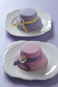 two plates with hats on them and one has a flower in the center, while the other is decorated