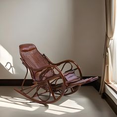 a rocking chair sitting in front of a window