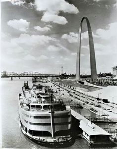 a large boat is docked in front of the st louis arch