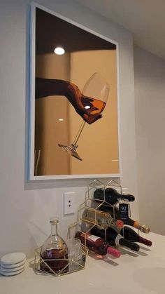 a wine glass is being held up by someone's hand in front of a mirror