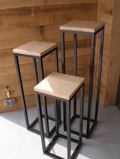 three wooden stools sitting next to each other