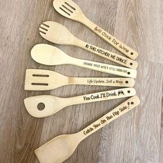 six wooden spoons and spatulas with words on them