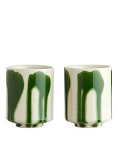 two green and white cups sitting next to each other