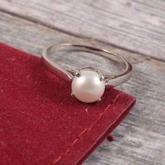 "This Sterling Silver Ring features an Elegant Art With Natural Pearl Gemstone. The cavity is made from genuine solid 925 sterling silver and stamped as S925. This Jewelry is Lead free and Rhodium plated to resist scratches and tarnish. ITEM DESCRIPTION Item Code: JARG160 Metal: 925/92.5 Sterling Silver Gemstone: Genuine Natural Cultured Pearl Gemstone Shape: Round Gemstone Size: 7 MM Round Ring Length: 7 MM Ring width: 7 MM Weight: 2.17 gm approx **Keep the jewelry away from direct heat, water, White Gold Round Cut Pearl Promise Ring, Sterling Silver Pearl Ring With Polished Finish, Timeless Silver Round Birthstone Ring, Sterling Silver Rings In White Gold With Classic Design, Hallmarked Sterling Silver Pearl Ring, Elegant Pearl Ring With Birthstone, Elegant Pearl Birthstone Ring, Silver Sterling Silver Pearl Ring With Polished Finish, Silver Pearl Ring With Polished Finish In Fine Jewelry