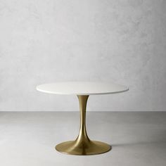 an oval white table with gold base