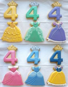 decorated cookies in the shape of princess dresses