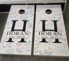 two cornhole boards that have been decorated with handwritten letters