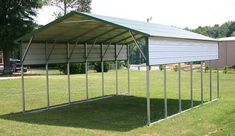 a large metal carport sitting in the middle of a field