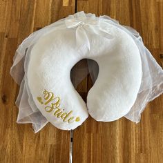 a white ring pillow sitting on top of a wooden floor